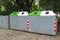 waste separation concept. Different Colored bins for collection of recycle materials near park. Green garbage and white is used to