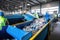 Waste sorting plant. Many different conveyors and bunkers. Workers sort the garbage on the conveyor. Waste disposal and recycling