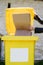 Waste sorting. Woman puts cardboard box in a yellow container