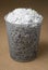 Wastepaper basket filled with shredded paper