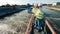 Wastewater operators taking a water sample at a sewage cleaning reservoir