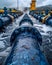 Wastewater pipes from industrial plants which is a large pipe made of metal. The wastewater flowing from the pipe is black and