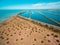 Wastewater treatment plant pools near ocean coastline.