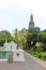 Wat Arun Ratchawararam or Temple of Dawn next to its gardens and some statues