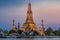 Wat Arun stupa, a significant landmark of Bangkok, Thailand, stands prominently along the Chao Phraya River, with a beautiful