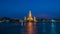 Wat Arun stupa, a significant landmark of Bangkok, Thailand, stands prominently along the Chao Phraya River, with a beautiful