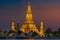 Wat Arun stupa, a significant landmark of Bangkok, Thailand, stands prominently along the Chao Phraya River, with a beautiful