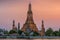 Wat Arun stupa, a significant landmark of Bangkok, Thailand, stands prominently along the Chao Phraya River, with a beautiful