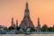 Wat Arun stupa, a significant landmark of Bangkok, Thailand, stands prominently along the Chao Phraya River, with a beautiful