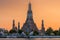 Wat Arun stupa, a significant landmark of Bangkok, Thailand, stands prominently along the Chao Phraya River, with a beautiful