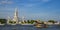 Wat Arun temple with river and transportation boat in Bangkok city