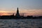 Wat Arun Temple stands on the banks of the Chao Phraya River at dusk