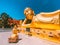 Wat Khao Sung Chaem Fa temple with giant snake and reclining gold buddha, in Kanchanaburi, Thailand