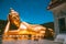 Wat Khao Sung Chaem Fa temple with giant snake and reclining gold buddha, in Kanchanaburi, Thailand