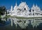 Wat Rong Khun is reflected in lake as in a mirror