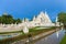 Wat Rong Khun The White Abstract Temple and pond with fish, in Chiang Rai, Thailand