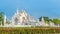 Wat Rong Khun The White Abstract Temple and pond with fish, in Chiang Rai, Thailand. Popular and famous