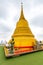 Wat Saket temple with golden stupa and angel statue. Symbol of buddhism in Bangkok city, Thailand. Majestic and religion symbol of