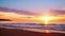 Watch as the sun sets over the ocean, casting a warm glow on the beach and creating a captivating view of the horizon, A beautiful