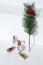 Watch, sequins bottles and spruce branch in white space. New Year, holiday, Christmas concept. Minimalism, Still life art