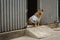 Watchdog dog sitting in front of house wearing t-shirt -