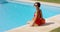 Watchful lifeguard sitting at side of pool