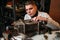 Watchmaker adjusts the mechanism of old wall clock