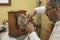 Watchmaker repairs mantelclock in his laboratory