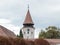 Watchtower with the clock of the Fortified Church Prejmer in Prejmer city in Romania