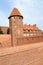Watchtower and a fragment of the fortress wall of the chivalrous castle of the Teutonic Order. Marlbork, Poland