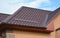 Wateproofing roof problem area with metal roof sheets and rain gutter. Lightweight metal roof tiles roofing construction