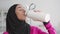 Water balance and sports. Close up portrait of positive muslim lady in hijab drinking water after fitness, free space