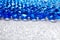 Water blue gel balls on silver shiny background. Polymer gel. Silica gel
