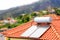 Water boiler with solar panels on roof of house