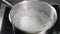Water boiling,Close-up sauce pot of boiling water, Bubbles of boiling water. slow motion. Top view. Cooking pot boiling