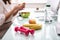 Water Bottle, Banana And Pink Dumbbells On Office Desk