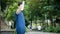 A water bottle in the hands of a young man after drinking in the park after jogging outdoors.