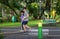 Water bottle on wooden table in park and blur family running athlete