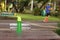 Water bottle on wooden table in park and blur running athlete