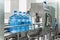 Water bottling conveyor line with plastic bottles or gallons on water factory production