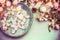 Water bowl with spring blossom and bokeh , top view, border. Springtime