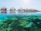 Water bungalows in a Maldives island resort with under water coral reefs