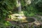 Water called `One waterfall` flowing over a small ledge and into a pond in Bali. Scenic view of cool refreshing hidden waterfall