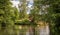 Water canal with a brick house in the background - Spreewald, Germany.