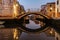 Water canal,bridge at dusk,Venice,Italy.Typical boat transportation,Venetian travel urban scene.Water transport.Popular tourist