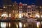 Water of canal in front of traditional Dutch houses in Amsterdam, Netherlands, March 23, 2019