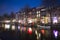 Water of canal in front of traditional Dutch houses in Amsterdam, Netherlands, March 23, 2019