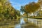 Water canal in southern French town under clear blue skies