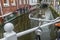 Water canal and street with bicycle parking lot in Dutch Delft old city