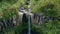 Water cascade flowing high cliffs aerial view. Cold stream rushing down nature